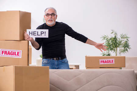 Old male professional mover doing home relocation