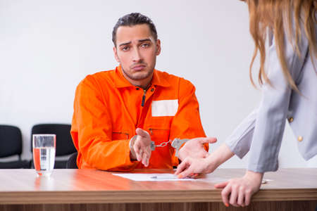 Young man meeting with advocate in pre-trial detentionの写真素材