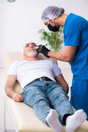 Old man visiting male doctor for plastic surgery