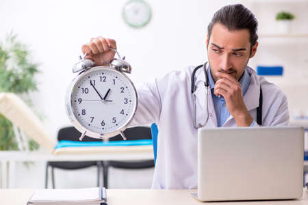 Young handsome male doctor working in the clinicの写真素材