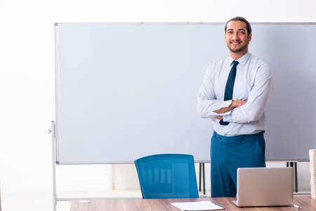 Young male employee in business presentation conceptの写真素材