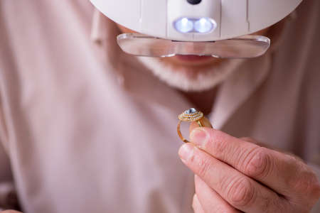 Old jeweler at the workshop