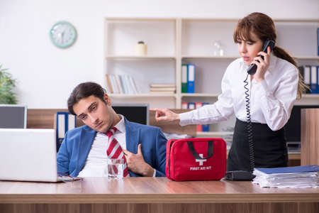 Young employee suffering in the officeの写真素材