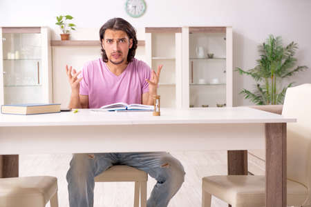 Young male student preparing for exams at homeの写真素材