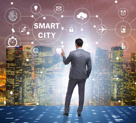 Concept of smart city with businessman pressing buttonsの写真素材