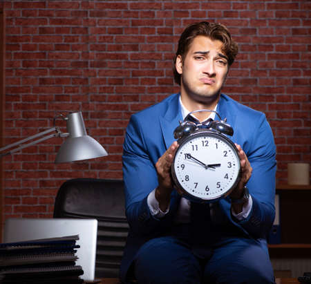 Young businessman working in the office at nightの写真素材