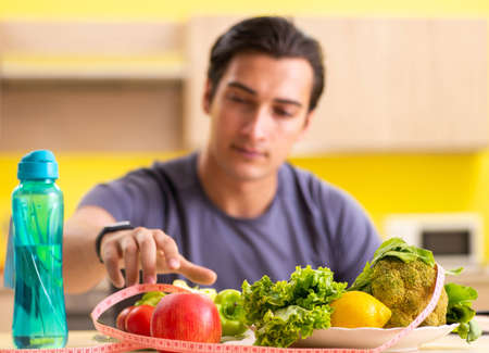 Young man in dieting and healthy eating conceptの写真素材