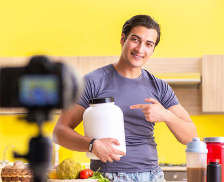 Young man blogging about food supplementsの写真素材