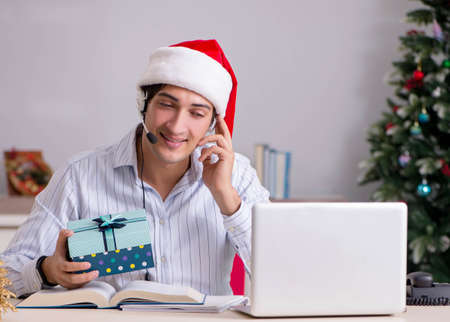 Telesales operator during christmas sale on the phoneの写真素材