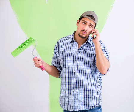 Young painter doing renovation at home