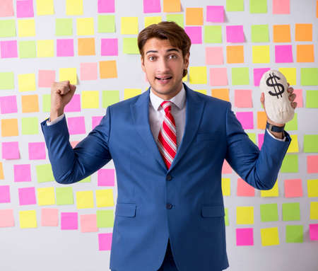 Young handsome man in conflicting priorities conceptの写真素材