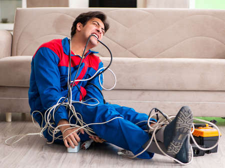 Electrician contractor with tangled cablesの写真素材