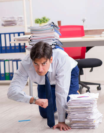 Extremely busy employee working in the officeの写真素材