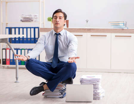 Extremely busy employee working in the officeの写真素材