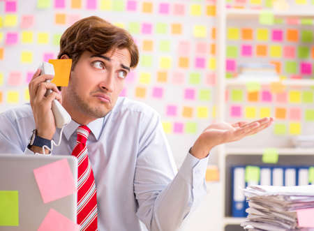 Young handsome man in conflicting priorities conceptの写真素材