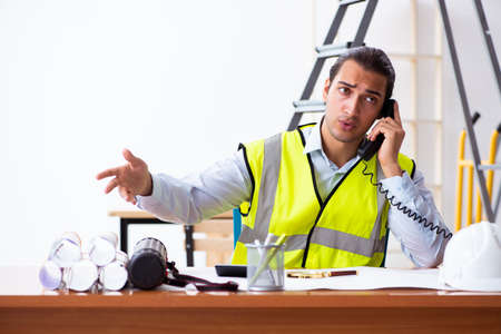 Young male architect working indoors