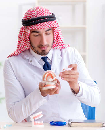 Arab dentist working on new teeth implantの写真素材