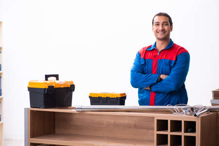 Young handsome male carpenter working indoorsの写真素材