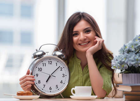 Student with gian alarm clock preparing for exams