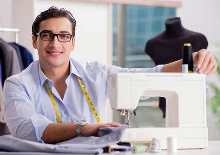Young man tailor working on new clothingの写真素材