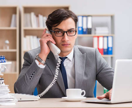 Handsome businessman working in the officeの写真素材