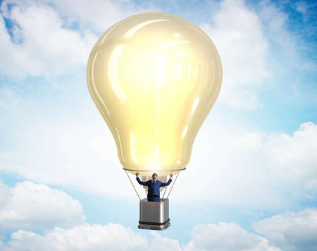 The businessman flying on hot balloonの写真素材