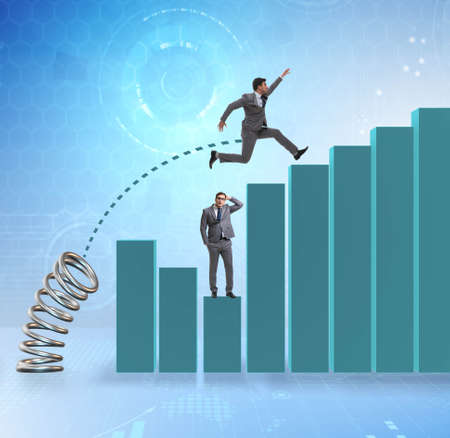 The businessman outperforming his competition jumping overの写真素材