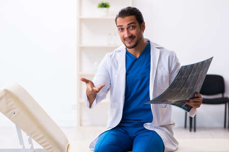 Young male doctor working in the clinicの写真素材