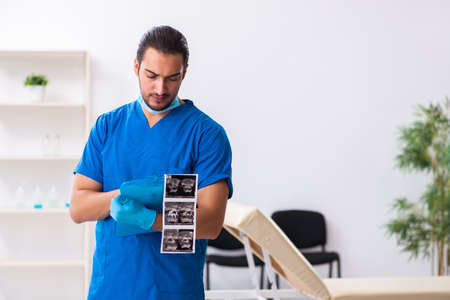 Young male doctor working in the clinicの写真素材