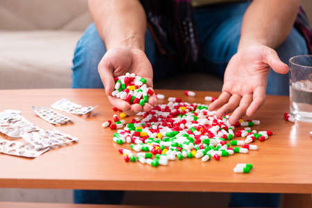 Young man suffering at homeの写真素材