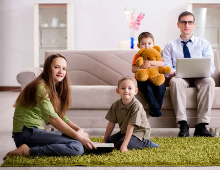 Father is trying to work while children are playingの写真素材