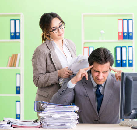 Man employee suffering from excessive workの写真素材