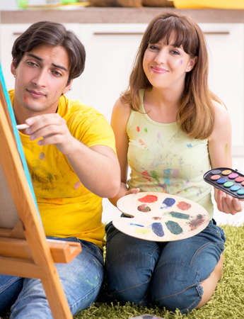 Young couple enjoying painting at homeの写真素材