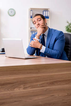 Young male businessman employee working in the officeの写真素材
