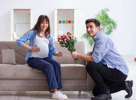 Happy family celebrating pregnancy at homeの写真素材