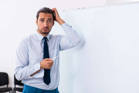 Young male employee in business presentation conceptの写真素材