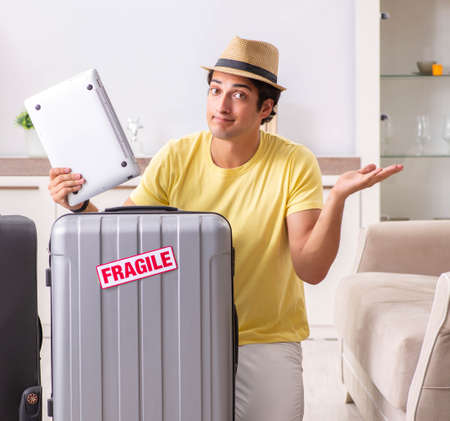 Man going on vacation with fragile suitcasesの写真素材