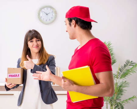 Courier delivering parcel to the officeの写真素材