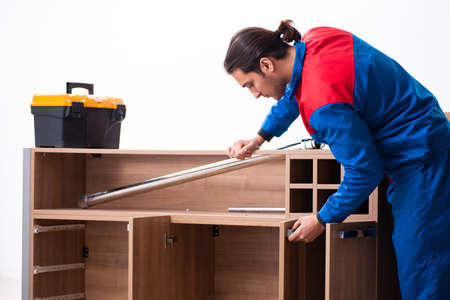 Young handsome male carpenter working indoorsの写真素材