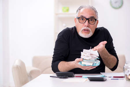 Old male retired in budget planning conceptの写真素材