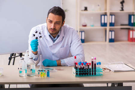 Young male chemist working in the lab