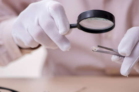 Old jeweler at the workshopの写真素材