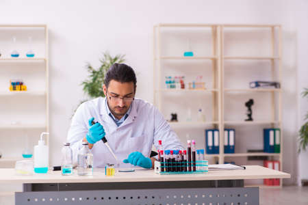 Young male chemist working in the labの写真素材