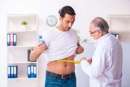 Doctor dietician giving advices to fat overweight patientの写真素材