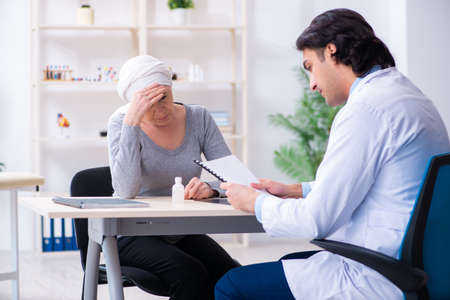 The young male doctor and female oncology patientの写真素材