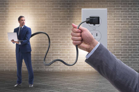 Businessman being powered by electricity and plug