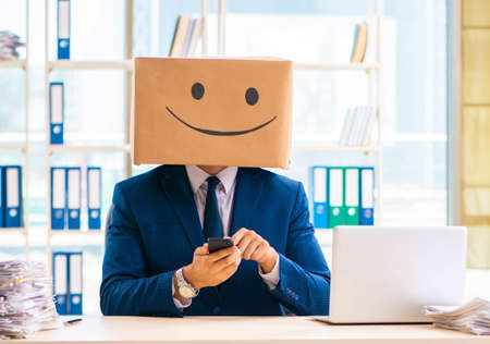 Happy man with box instead of his headの写真素材