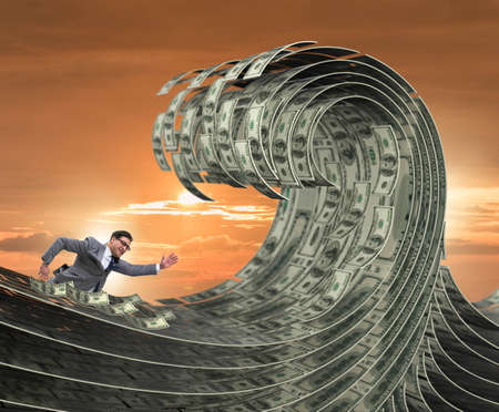 Businessman swimming in the sea of dollar money