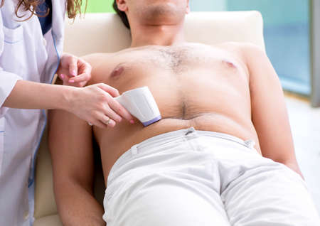 Young man visiting doctor for epilationの写真素材