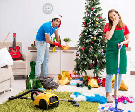 Young family cleaning apartment after christmas partyの写真素材